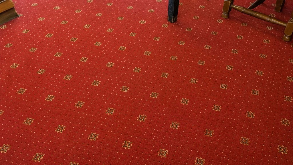 A very clean, red pub carpet after being steam cleaned by Revita.