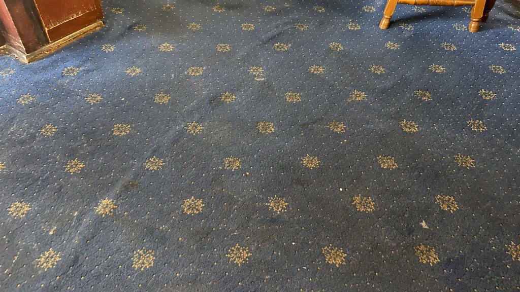 A very dirty, blue pub carpet.